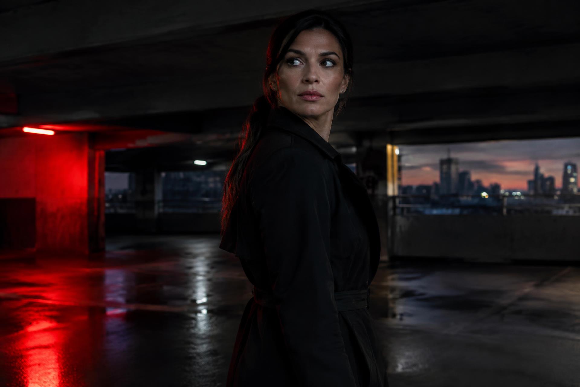 Woman standing alert and aware in a dim parking garage